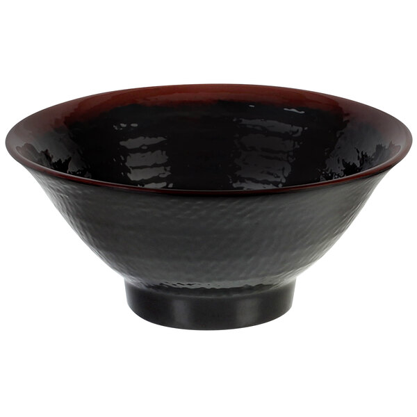 A close up of a black Thunder Group Tenmoku melamine bowl with a red rim.