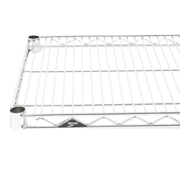 A Metro stainless steel wire shelf with two holes.
