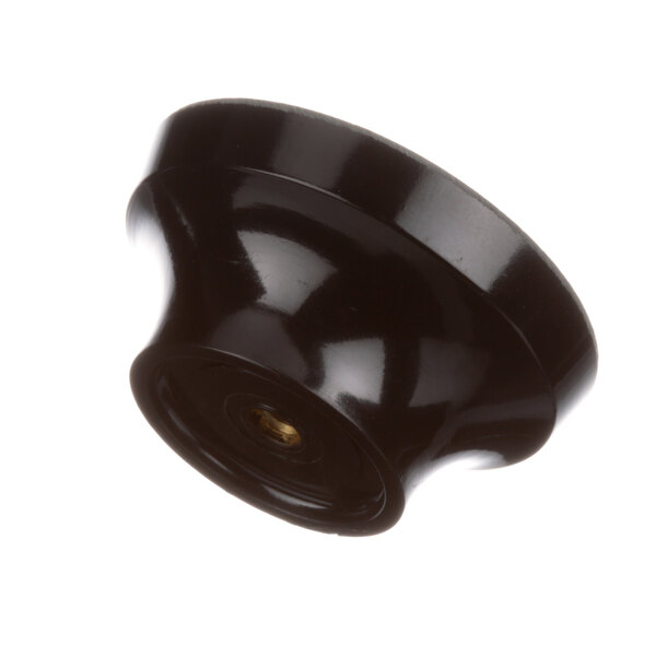A close-up of a black Server Products knob with a hole in the middle.