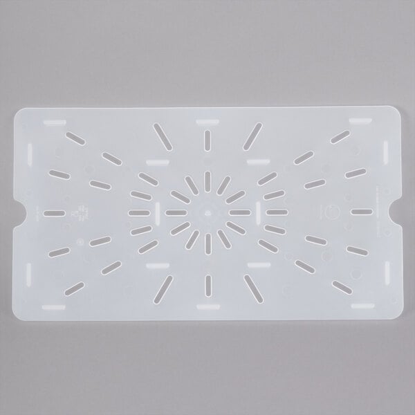 A white plastic surface with holes for draining.
