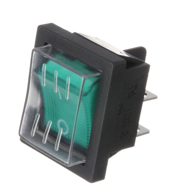 A close-up of a green Adcraft PS Rocker Switch with a clear plastic cover.