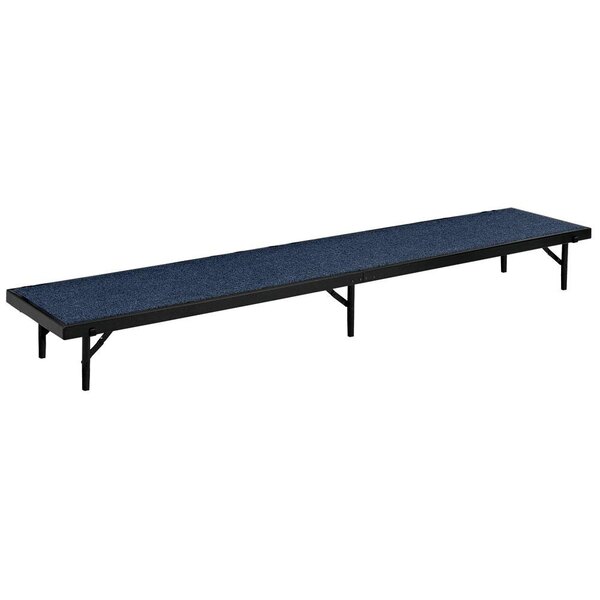 A blue carpeted National Public Seating portable stage riser.