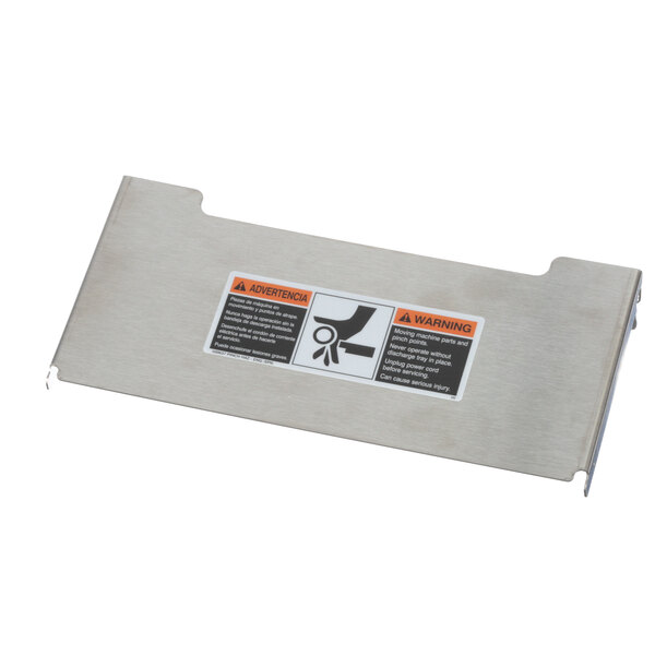 A silver metal Bettcher discharge tray with an orange warning label.