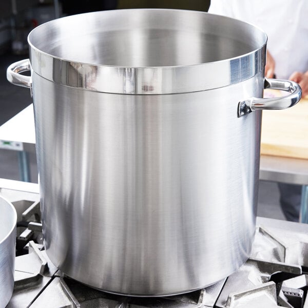 A large silver Vollrath Centurion stock pot on a stove.