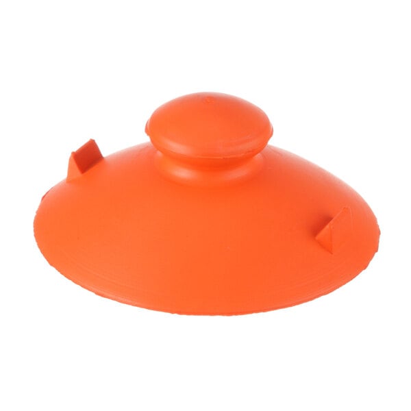 An orange rubber lid with a round top and a hole.