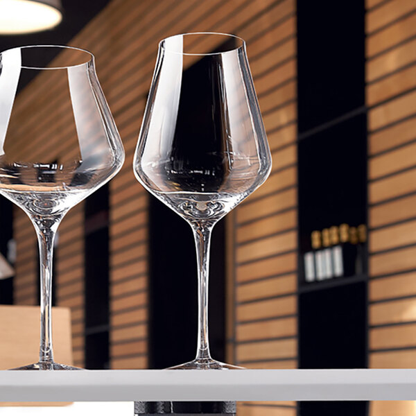 Two Chef & Sommelier Reveal' Up wine glasses on a table.