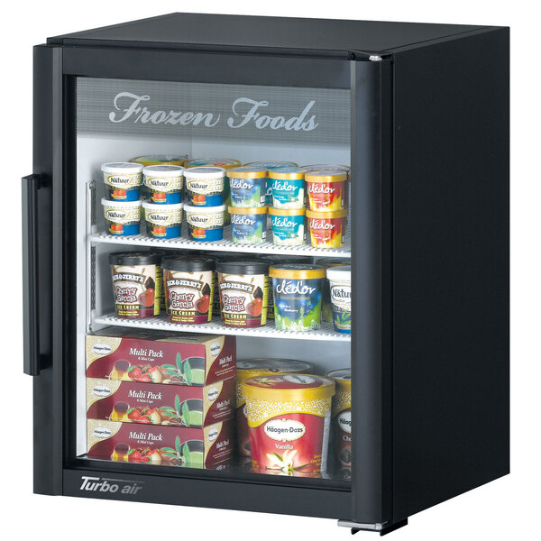 A black Turbo Air countertop display freezer with various food items inside.