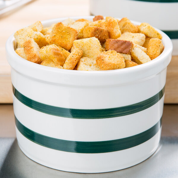 A CAC green striped bain marie jar filled with croutons.