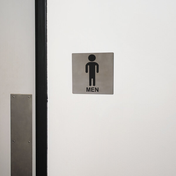 A Tablecraft stainless steel men's restroom sign on a wall.