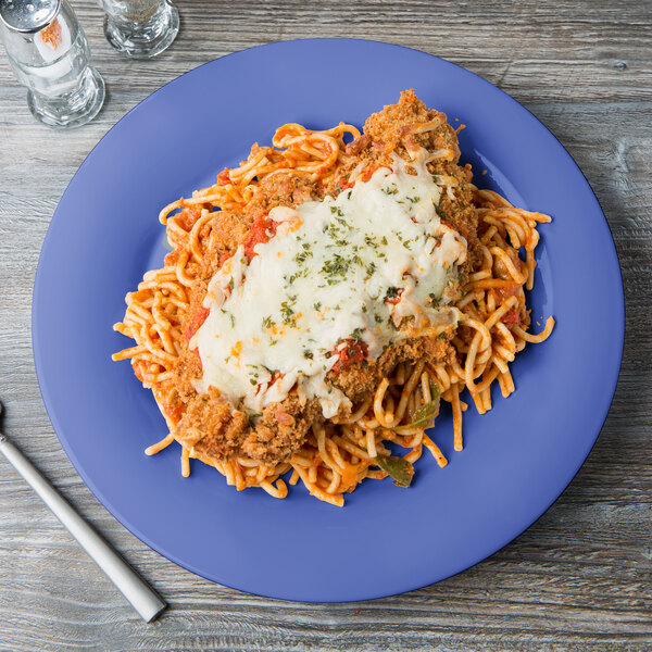 A GET peacock blue melamine plate with spaghetti topped with meat and cheese.