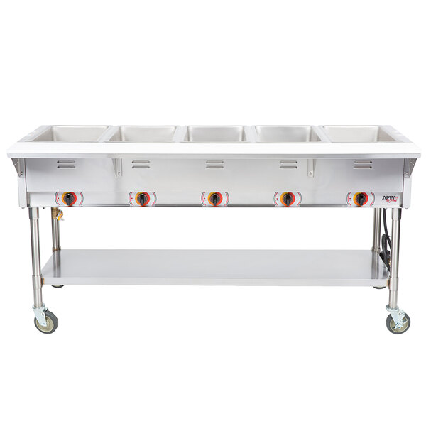 An APW Wyott stainless steel portable steam table with five sealed wells on a counter in a school kitchen.