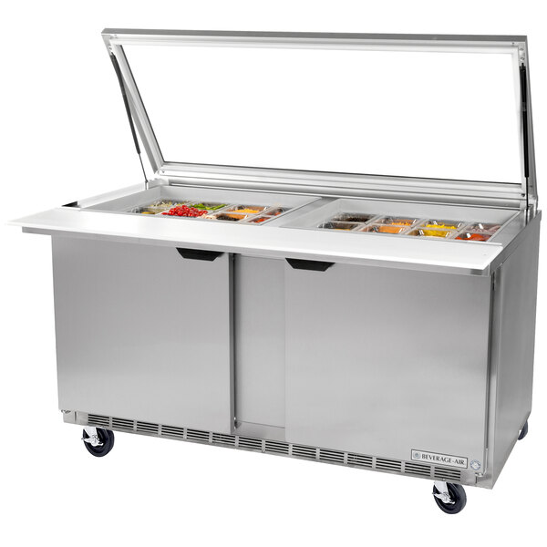 A Beverage-Air stainless steel sandwich prep table with two glass lids over trays.