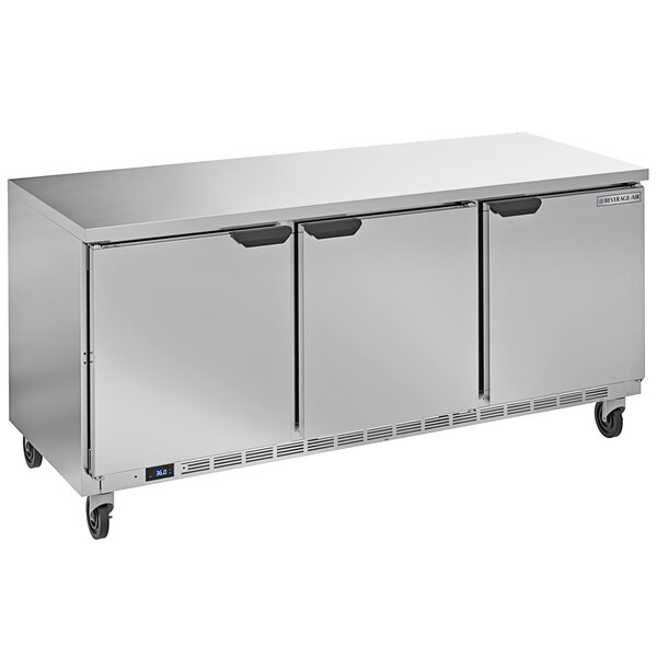 A silver stainless steel Beverage-Air worktop refrigerator with three doors.