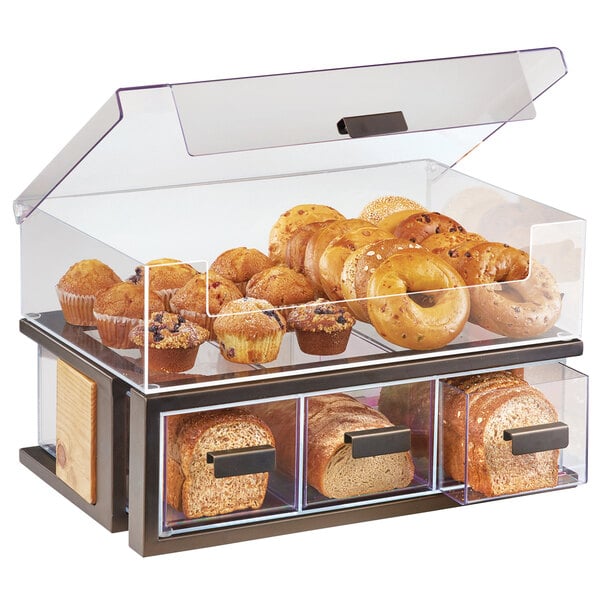 A Cal-Mil bread display case filled with bread and bagels.