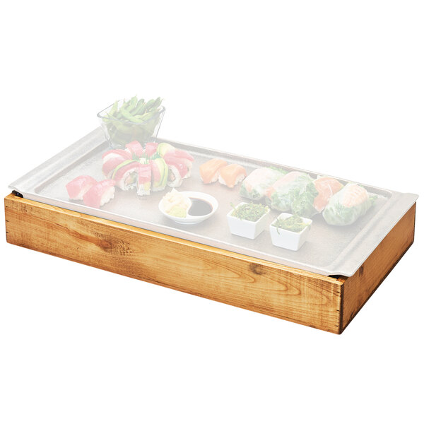 A Cal-Mil Madera wood tray with sushi and vegetables on it.