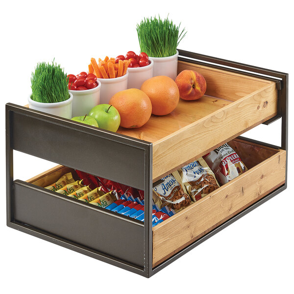 A Cal-Mil Sierra merchandiser rack on a counter with fruit and vegetables displayed on it.
