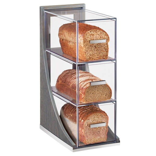 A Cal-Mil Ashwood bread display case with three loaves of bread inside.