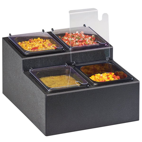 A black two tier Cal-Mil condiment bar with four compartments holding food.