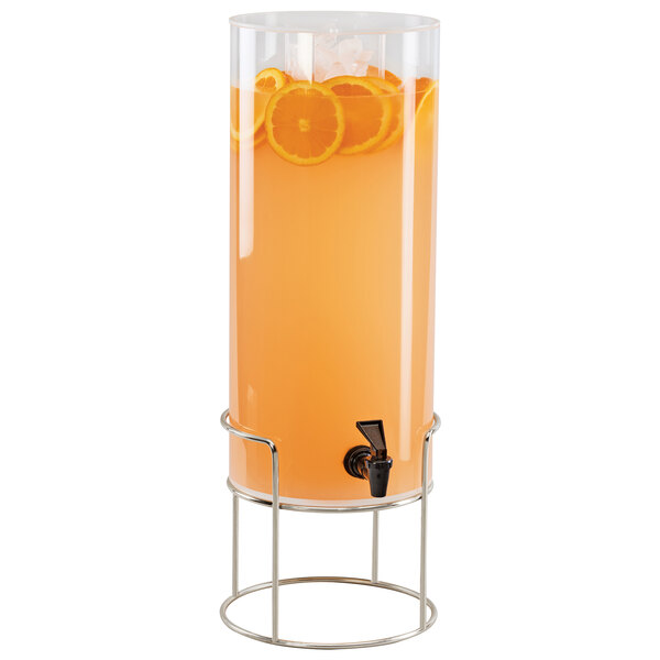 A Cal-Mil round plastic beverage dispenser with orange juice inside and a chrome wire base.