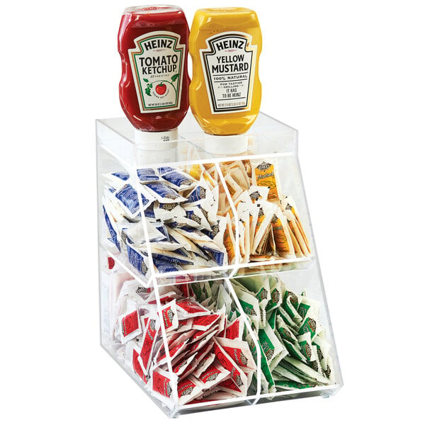A Cal-Mil clear plastic condiment holder with 4 bins holding ketchup and mustard.