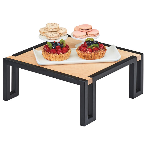 A Cal-Mil maple riser with fruit tarts on a table.