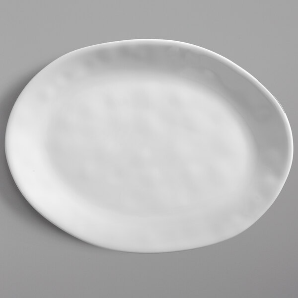 An American Metalcraft Crave oval melamine serving platter on a gray surface.