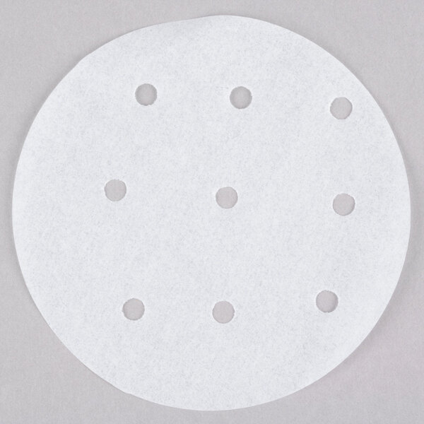 A white round paper disc with perforations.