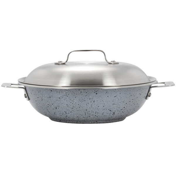 A Bon Chef stainless steel stir fry pan with a lid and handle.