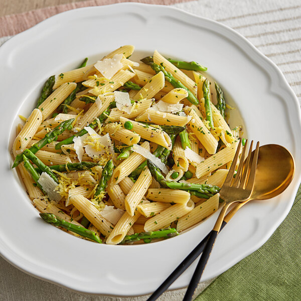 A plate of Napoli penne pasta with asparagus and parmesan cheese.