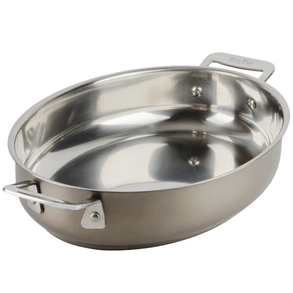 A taupe stainless steel Bon Chef oval au gratin dish with handles.
