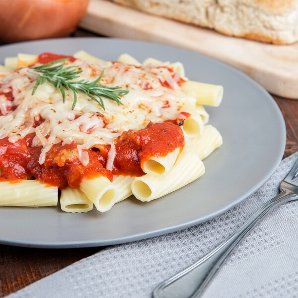 A plate of Napoli rigatoni pasta with tomato sauce and cheese and a fork.