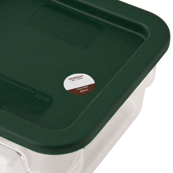 A plastic container with a green lid filled with Noble Products Thursday 1" Removable Day of the Week labels.