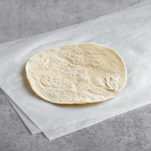 A Father Sam's Bakery flour tortilla on white paper.