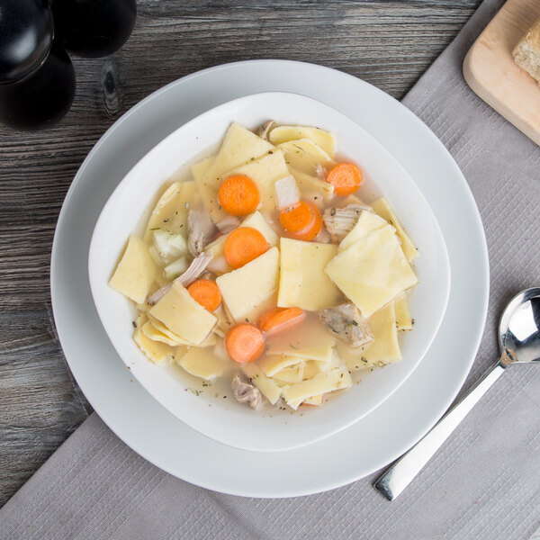 A bowl of chicken noodle soup with Little Barn Noodles and vegetables.