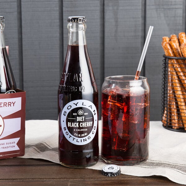 A Boylan Diet Black Cherry Soda bottle next to a glass of ice and a straw.