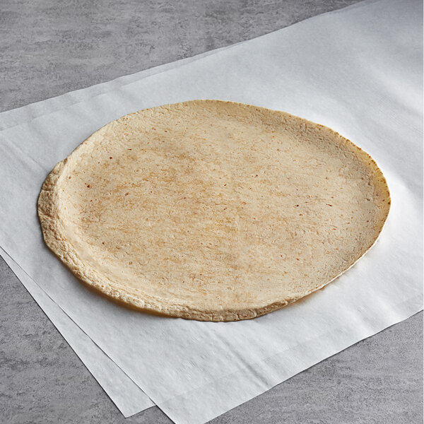 A Father Sam's Bakery sundried tomato tortilla on a white surface