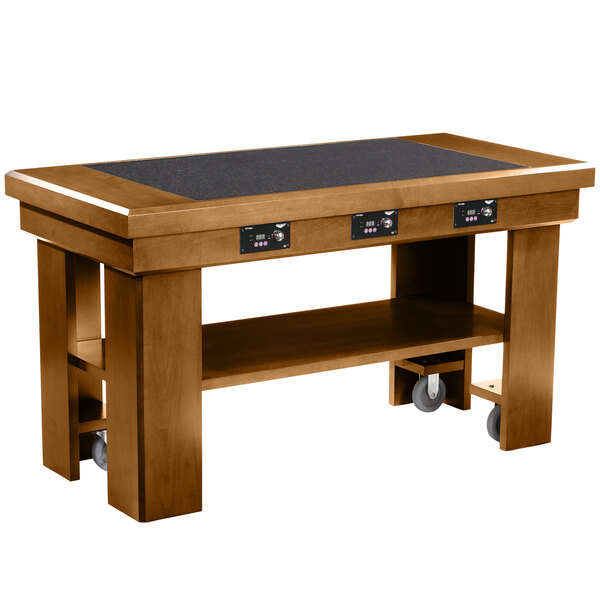 A Vollrath oak induction buffet table with wheels.