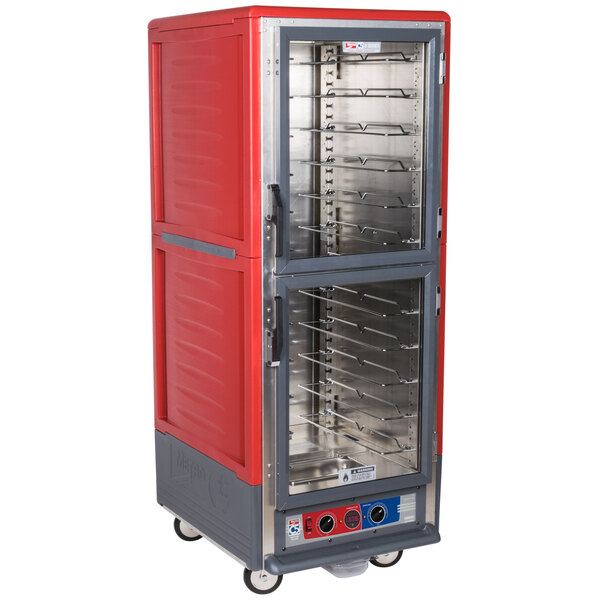 A red and silver Metro C5 moisture heated holding and proofing cabinet with clear Dutch doors.