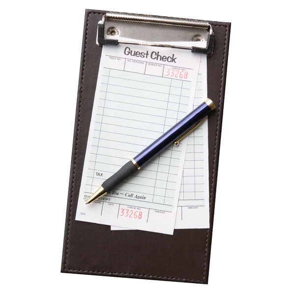 A Menu Solutions leather-like check presenter with a pen clipped to it with a Menu Solutions check presenter on a counter.