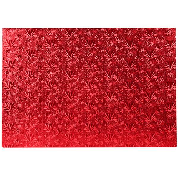 A white rectangular Enjay red floral patterned cake board.