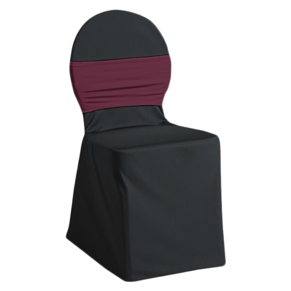 A black chair with a Snap Drape Silhouette II burgundy chair cover with a red band.