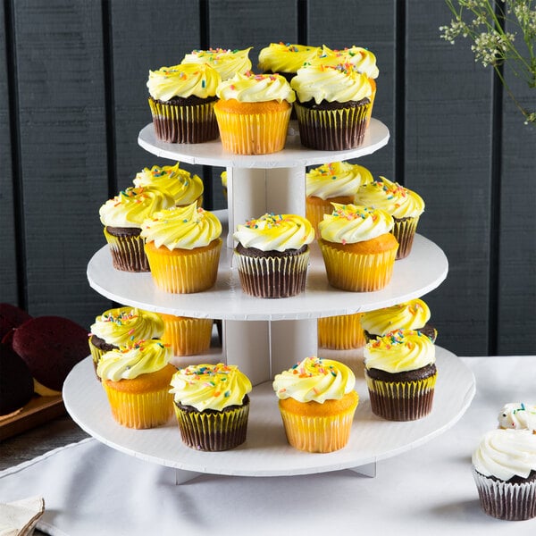 A white Enjay cupcake stand with yellow cupcakes on it.