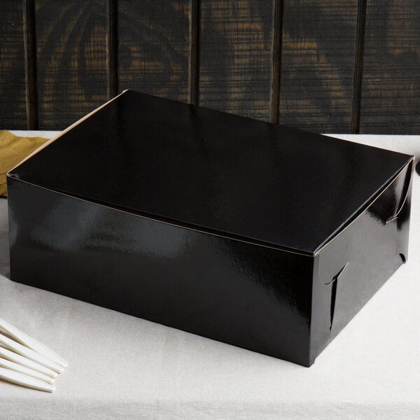 A black Enjay 1/4 sheet cake box on a white table.