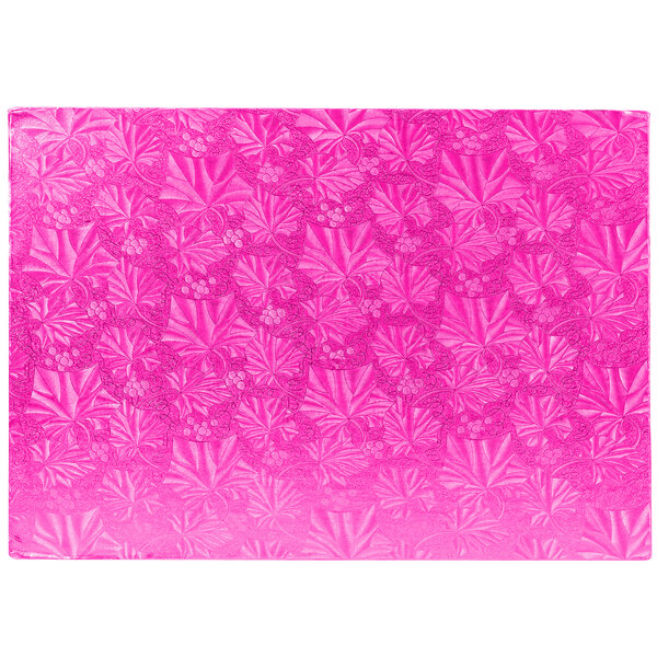 A pink rectangular Enjay cake board with a pattern of leaves and berries.