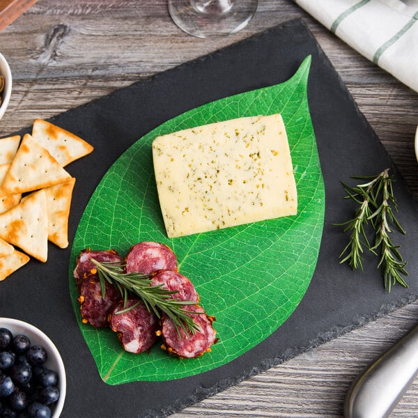 American Metalcraft Leaf Cheese Paper on a cheese plate with crackers and blueberries.