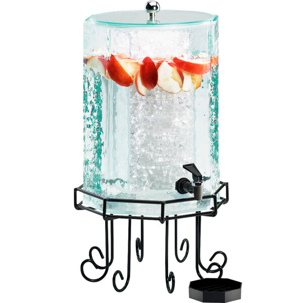 A Cal-Mil plastic octagonal beverage dispenser with ice and fruit inside.