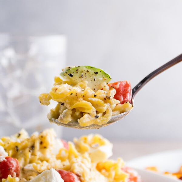 A spoonful of Costa medium egg noodles with tomatoes and cheese.
