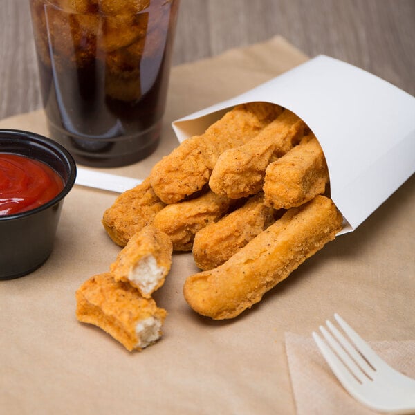 Brakebush Gold'N'Spice Chik'N Fry Stix in a paper bag with ketchup next to a drink.