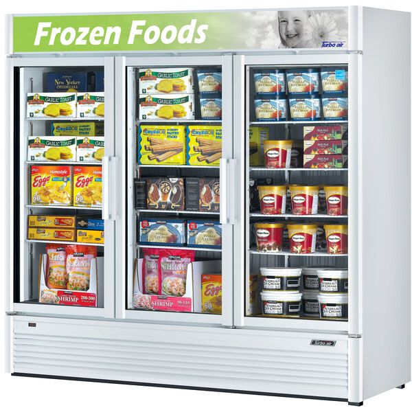 A Turbo Air white glass door merchandising freezer with frozen food inside.