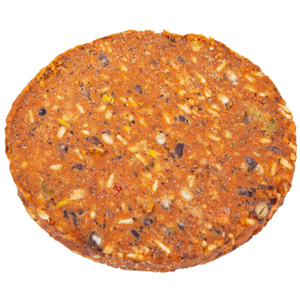 A close up of a Gardein Black Bean Veggie Burger, a round brown patty with different colored specks.